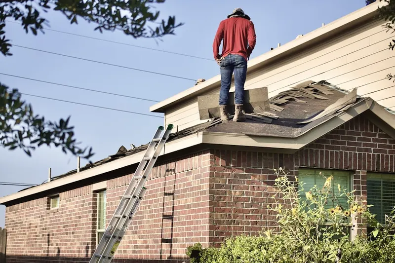 Professional roofer working on a residential roof in East Plymouth